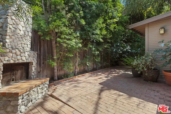 a backyard of a house with table and chairs
