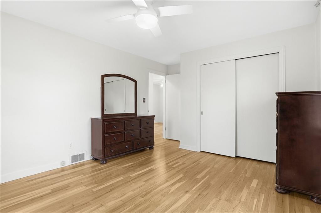 513 Lombard Street Irwin, PA 15642 - Photo 14 of 31 a view of a bedroom with wooden floor and cabinet