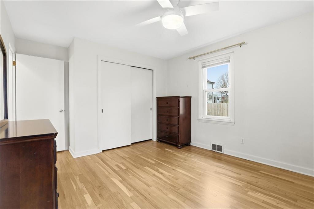 513 Lombard Street Irwin, PA 15642 - Photo 15 of 31 a view of an empty room with wooden floor and a window