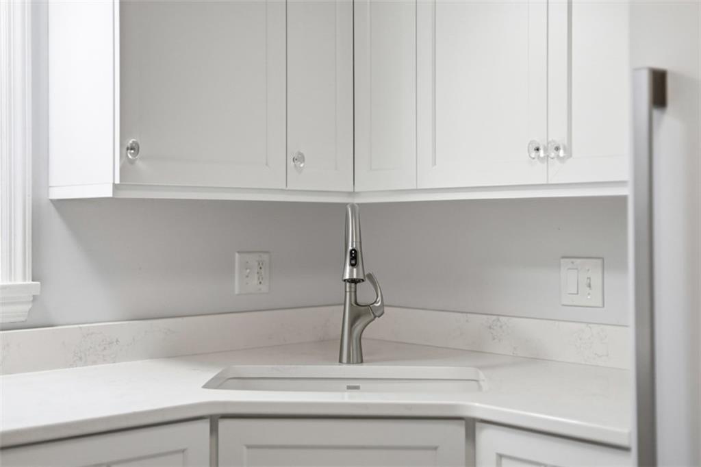 513 Lombard Street Irwin, PA 15642 - Photo 6 of 31 a sink with white cabinet