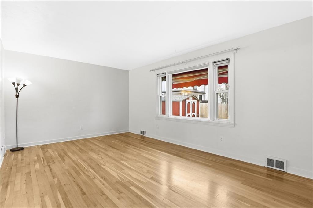 513 Lombard Street Irwin, PA 15642 - Photo 8 of 31 a view of an empty room with window and wooden floor