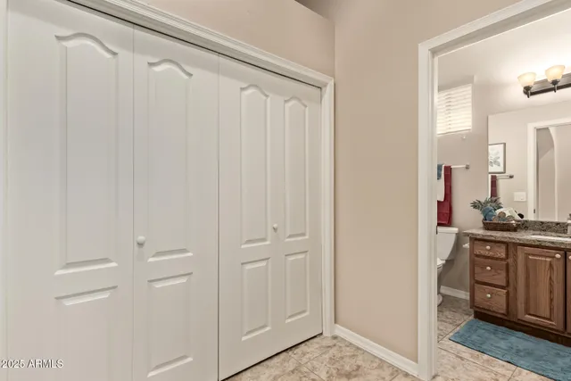 a bathroom with a granite countertop sink toilet mirror and bathtub