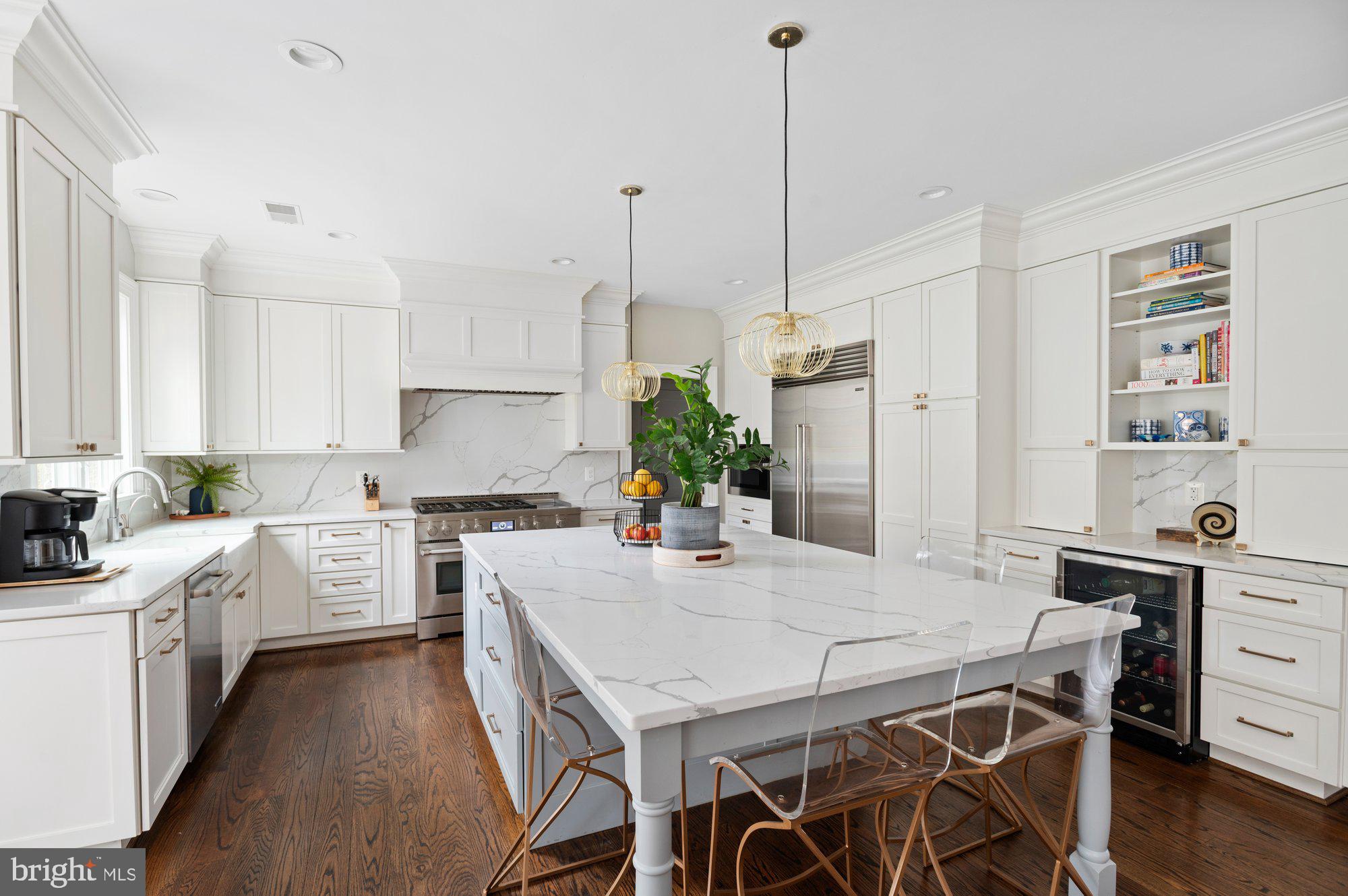 1610 Brookside Road McLean, VA 22101 - Photo 13 of 51 a kitchen with a table a sink cabinets and stainless steel appliances
