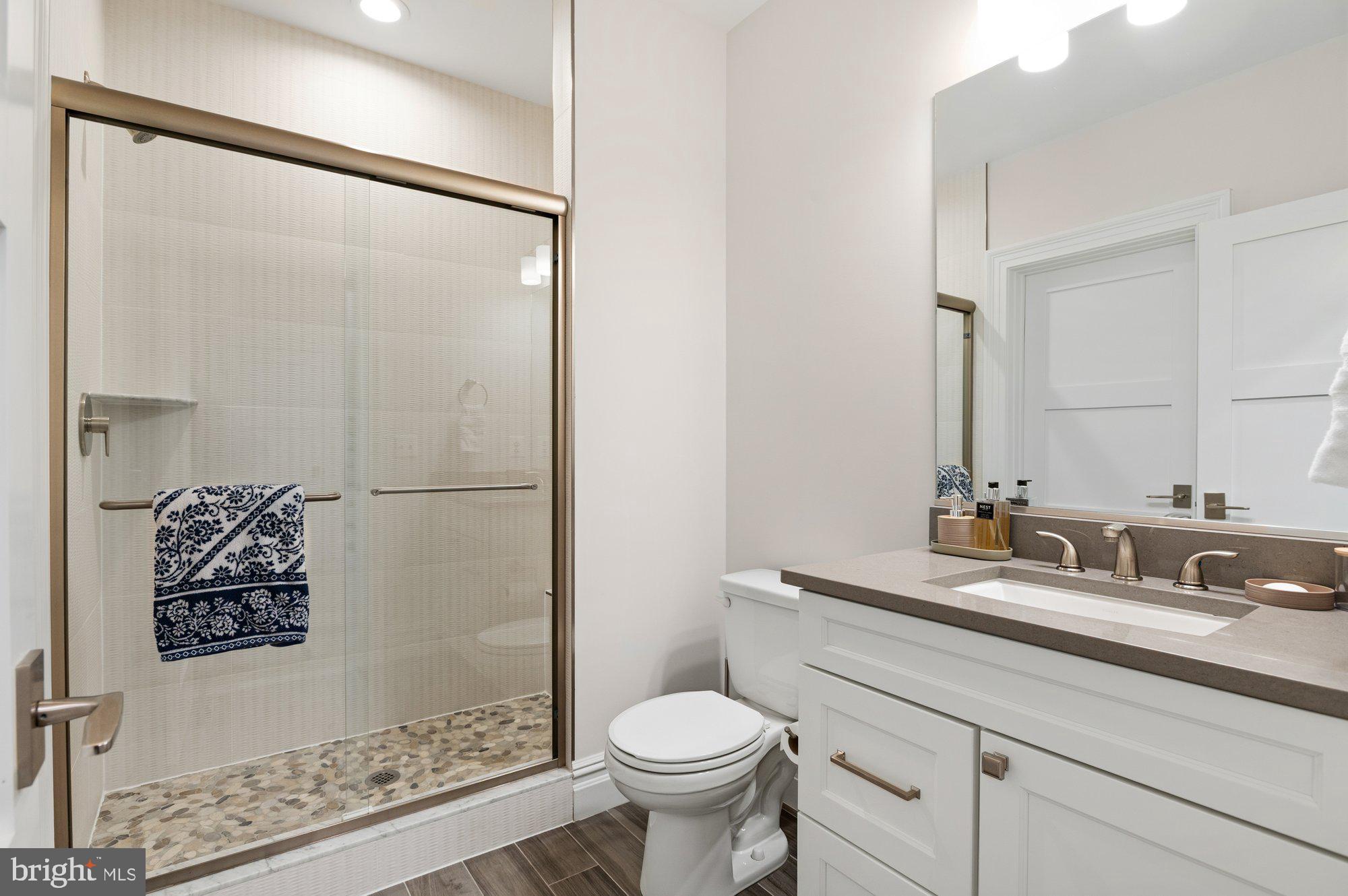 1610 Brookside Road McLean, VA 22101 - Photo 40 of 51 a bathroom with a granite countertop sink toilet and shower