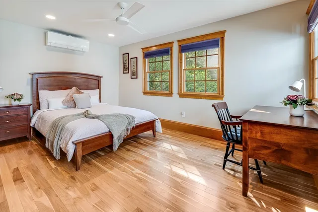 a bathroom with a granite countertop sink a toilet and a large mirror