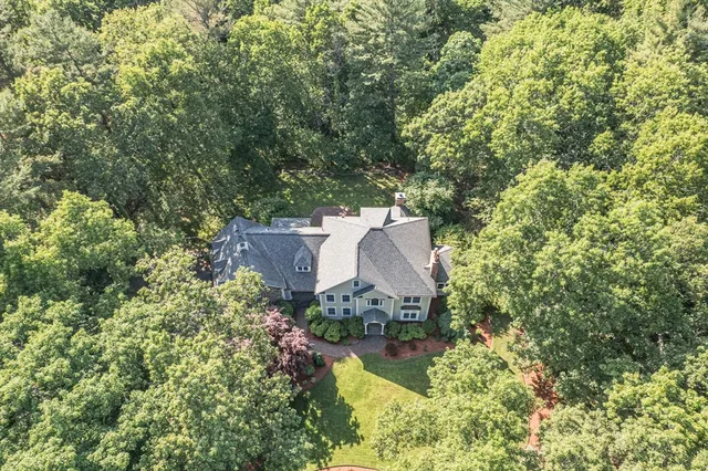 an aerial view of a house with a yard basket ball court and outdoor seating