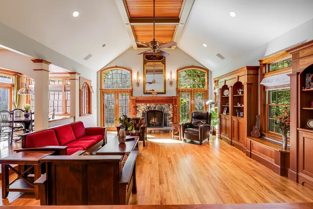 a living room with furniture a fireplace and a chandelier