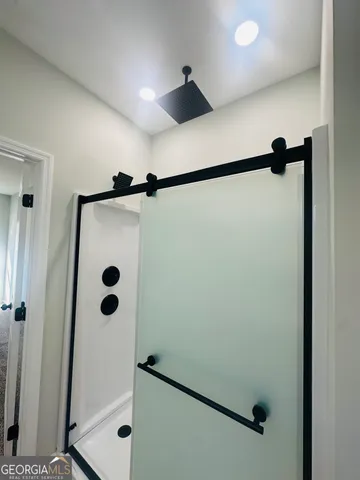 a bathroom with a shower and a shower