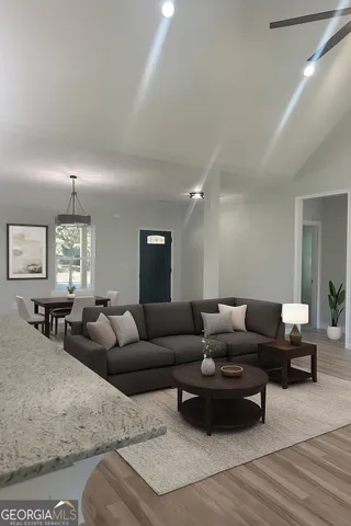 a living room with furniture and wooden floor