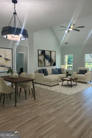 a living room with furniture and a chandelier