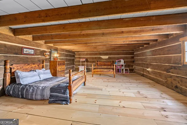 a bedroom with furniture and view of wooden floor