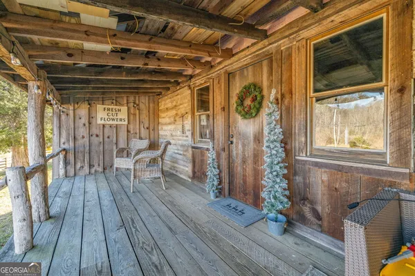a view of outdoor space with wooden floor and seating