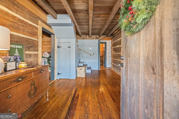 a spacious bathroom with a granite countertop sink a large mirror and shower