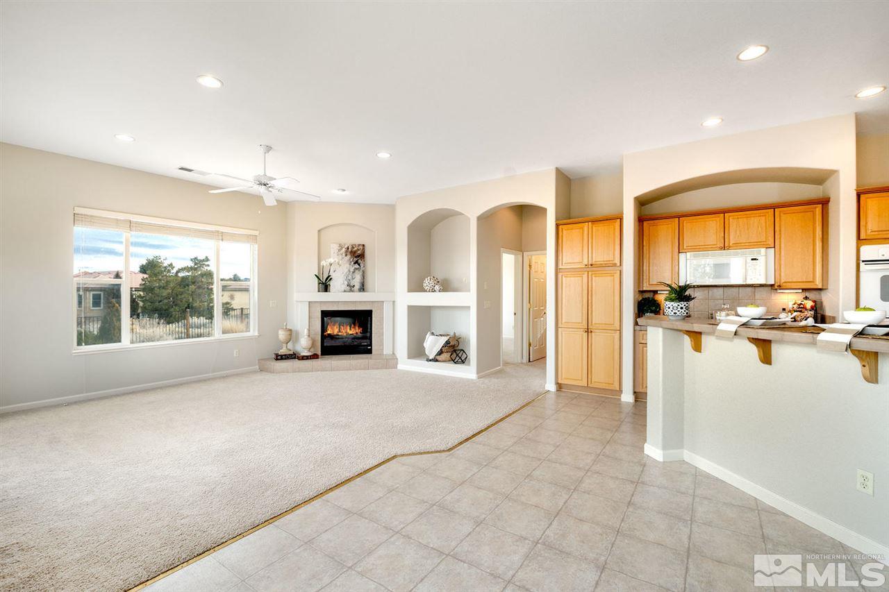 5665 North White Sands Road Reno, NV 89511 - Photo 9 of 25 a view of an empty room with a fireplace and a large window