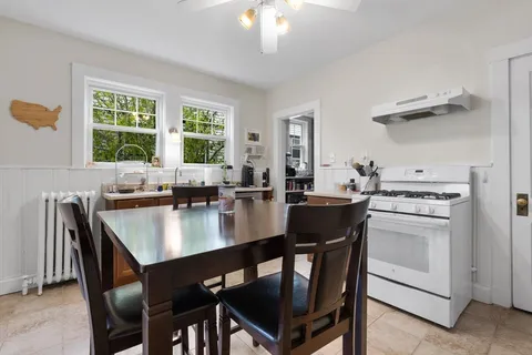 a view of a dining room kitchen with a table chairs and chandelier