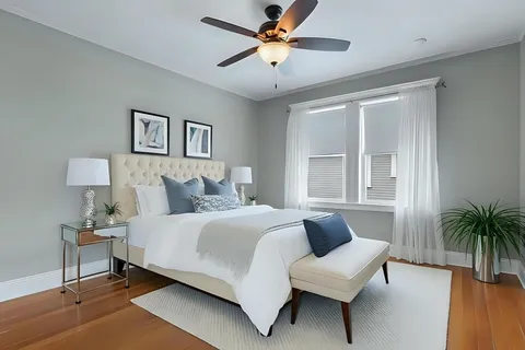 a bedroom with a large bed and a chandelier