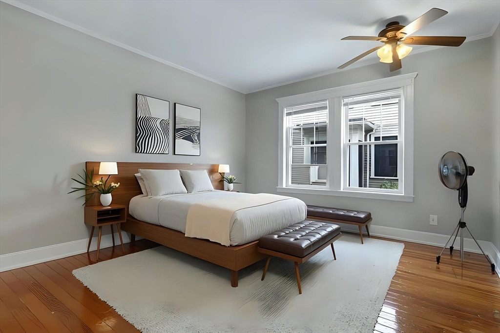 65-67 Halifax Street Boston, MA 02130 - Photo 7 of 21 a bedroom with a bed a chandelier and a window