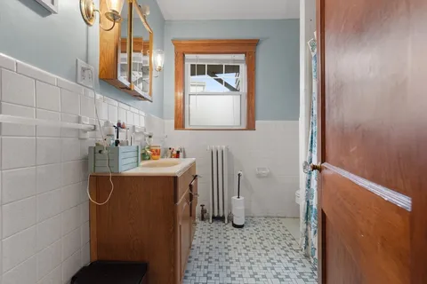 a bathroom with a sink a mirror and shower