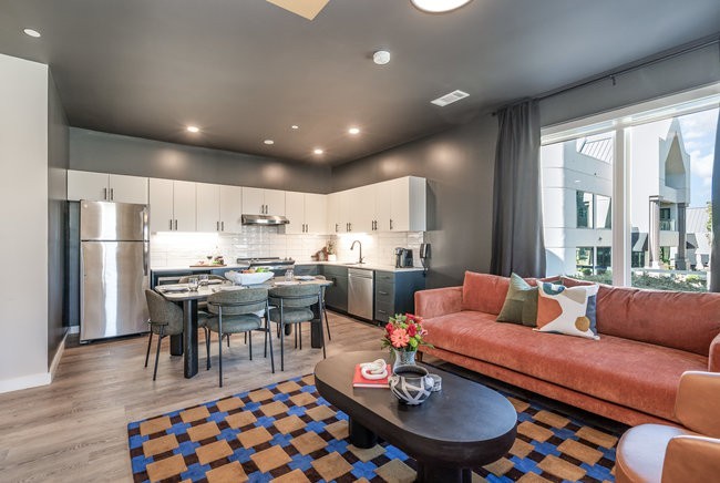 50 Music Square West, Unit 114 Nashville, TN 37203 - Photo 18 of 83 a living room with stainless steel appliances kitchen island granite countertop furniture and a dining table with wooden floor