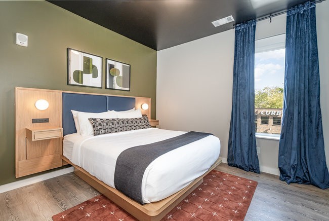 50 Music Square West, Unit 114 Nashville, TN 37203 - Photo 33 of 83 a bedroom with a large bed and a window