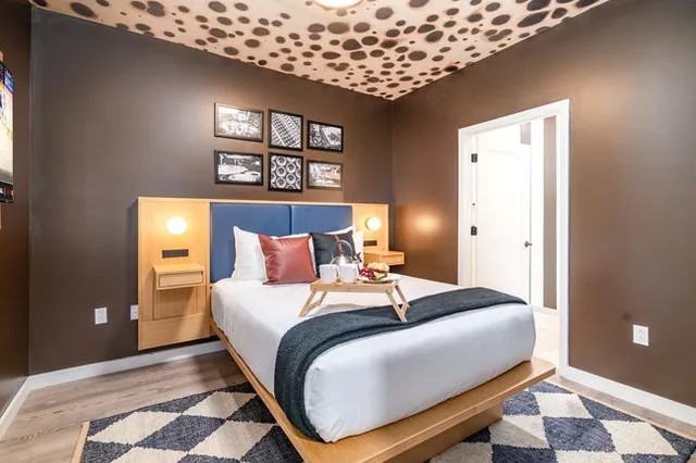 a large kitchen with stainless steel appliances kitchen island granite countertop a refrigerator and a sink