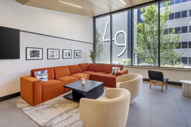 a view of an empty room with window and cabinet