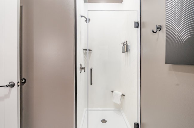 50 Music Square West, Unit 114 Nashville, TN 37203 - Photo 63 of 83 a bathroom with a glass shower door