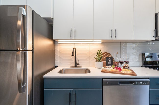 50 Music Square West, Unit 114 Nashville, TN 37203 - Photo 73 of 83 a kitchen with a sink and refrigerator