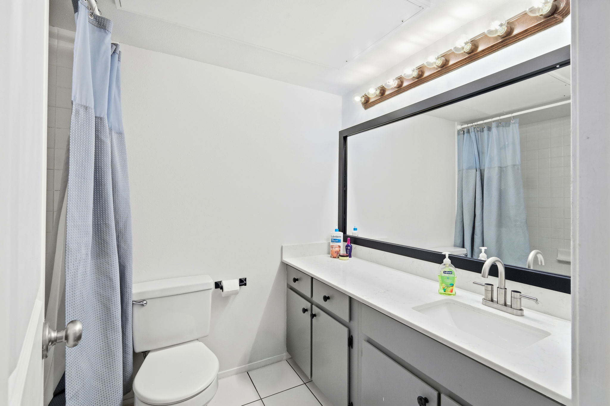 6910 Hart Lane, Unit 912 Austin, TX 78731 - Photo 15 of 36 Bathroom featuring a vanity with a white countertop, under-mount sink, and dual-handle faucet