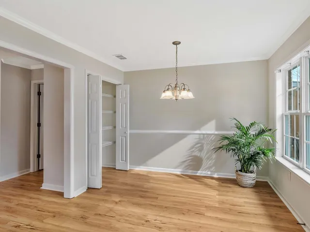 a bedroom with bed and a potted plant