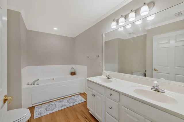 a bathroom with a sink a large mirror and a toilet