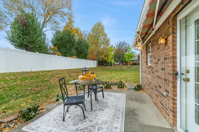a view of a patio with table and chairs and potted plants