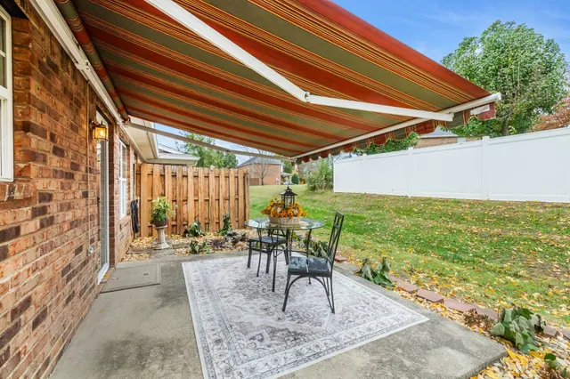 a view of a patio with a table and chairs
