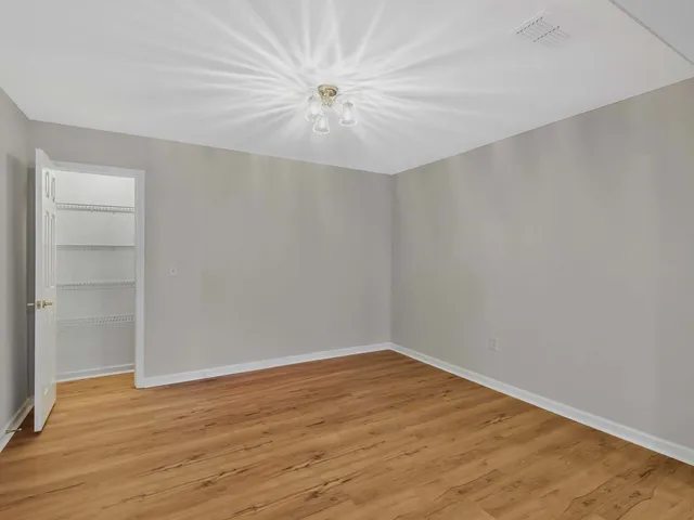 a view of a house with backyard and chairs