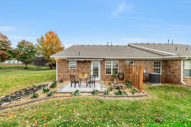 a view of a house with a yard porch and sitting area