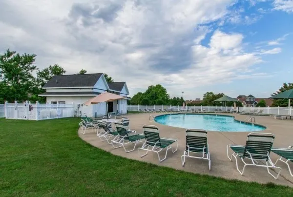 a view of a lake with table and chairs potted plants with lake view