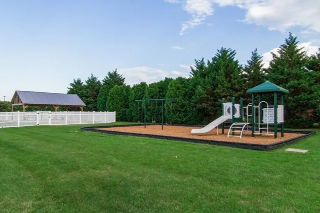 a view of a house with swimming pool and porch with furniture
