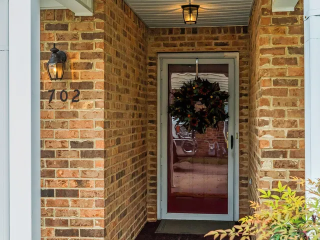 a view of empty room with wooden floor and window