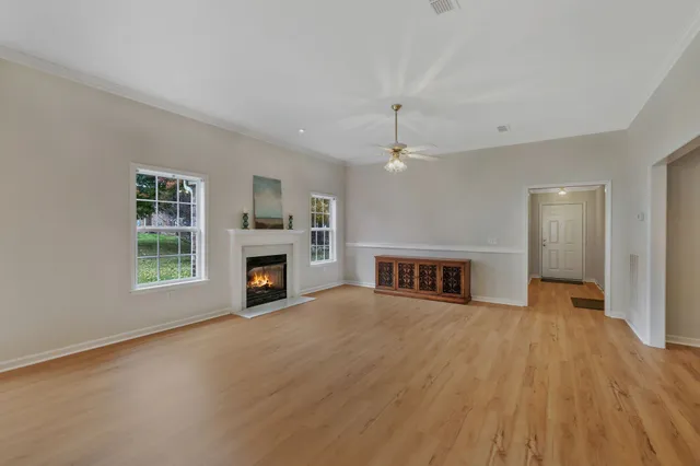 a view of a livingroom with a fireplace and window