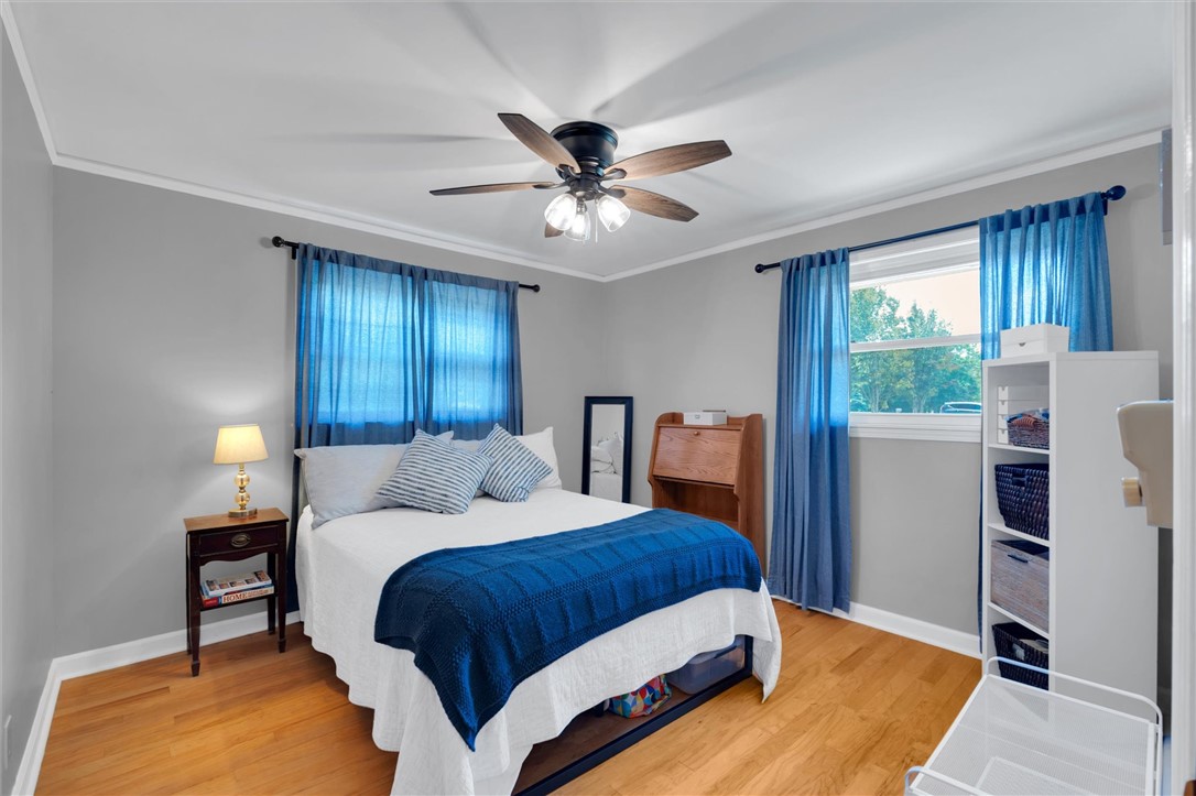1815 Pearman Dairy Road Anderson, SC 29625 - Photo 18 of 35 Hardwood floors and generous windows elevate this comfortable bedroom space.