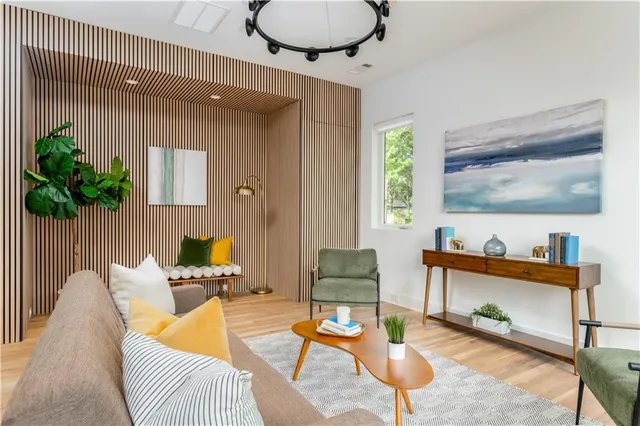 a living room with furniture a rug and a window