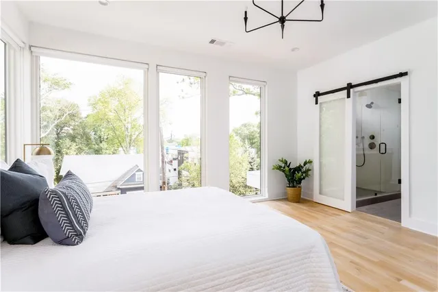 a bedroom with a large bed and a large window