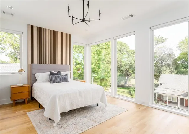 a bedroom with a large bed and a large window