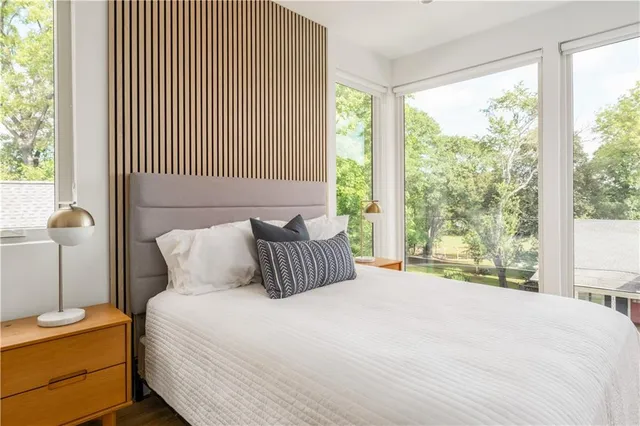 a bedroom with a large bed and a window