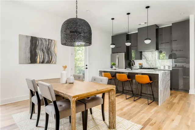 a dining table chairs and a chandelier