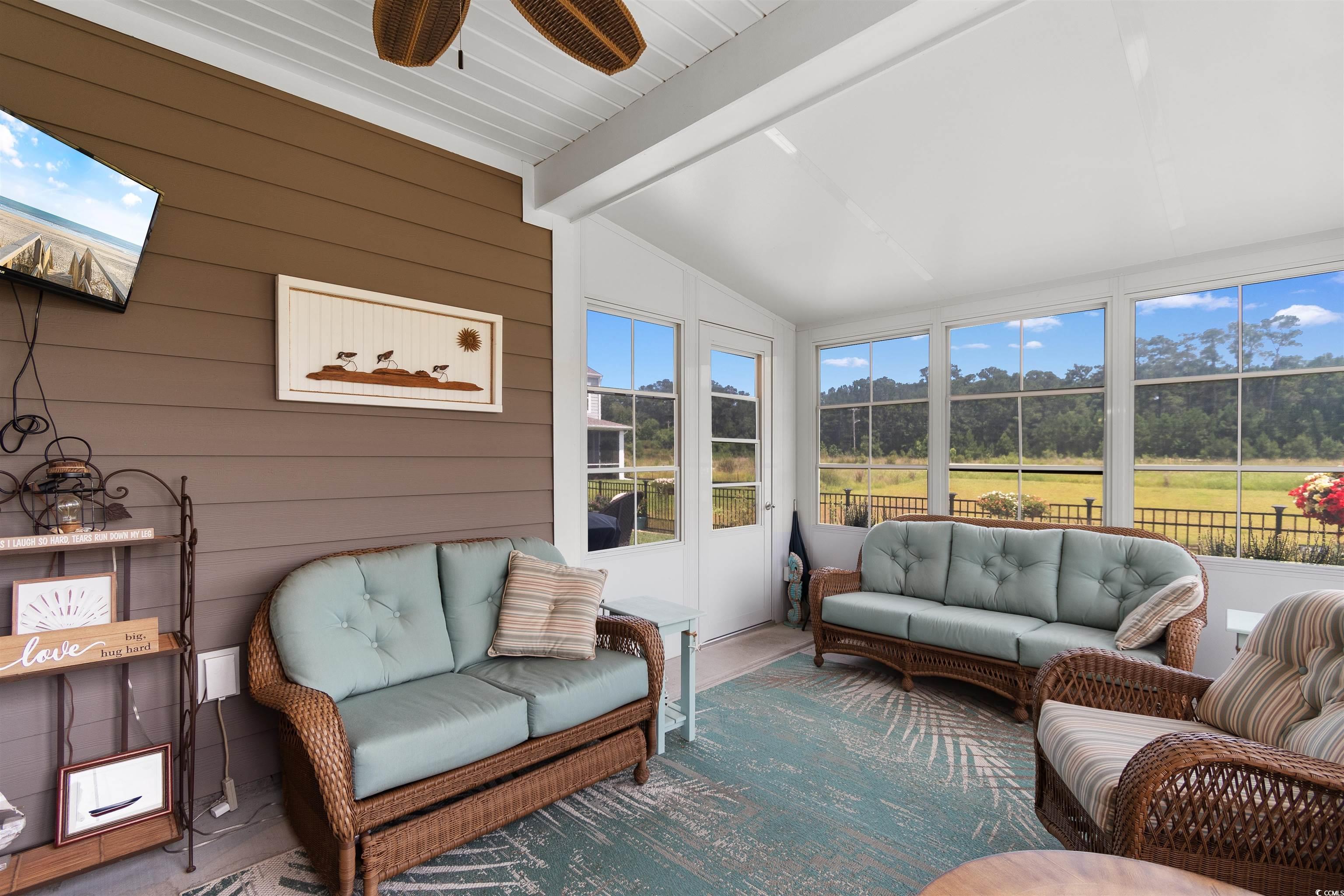 2438 Polaris Path Myrtle Beach, SC 29577 - Photo 24 of 40 Sunroom featuring outdoor lounge area and a ceiling fan