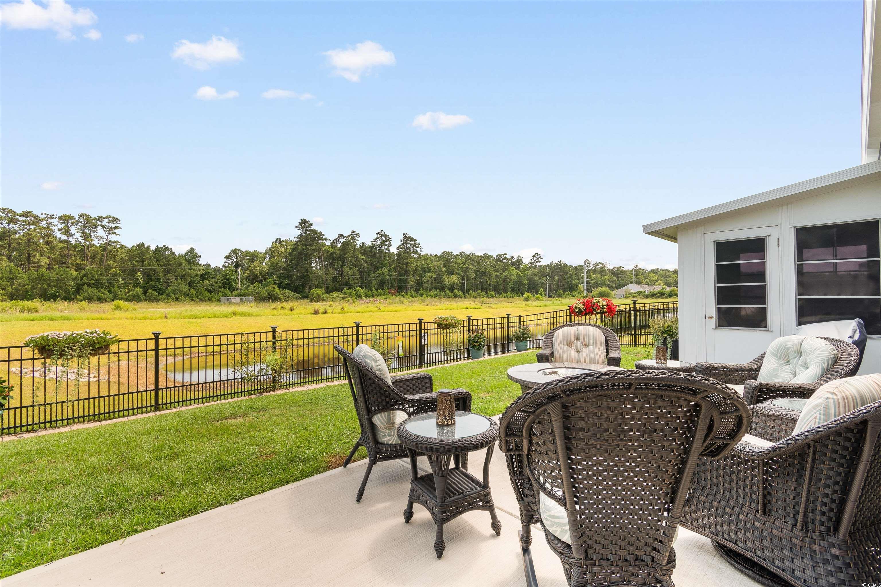2438 Polaris Path Myrtle Beach, SC 29577 - Photo 25 of 40 Fenced backyard with a patio, a water view, and view of wooded area