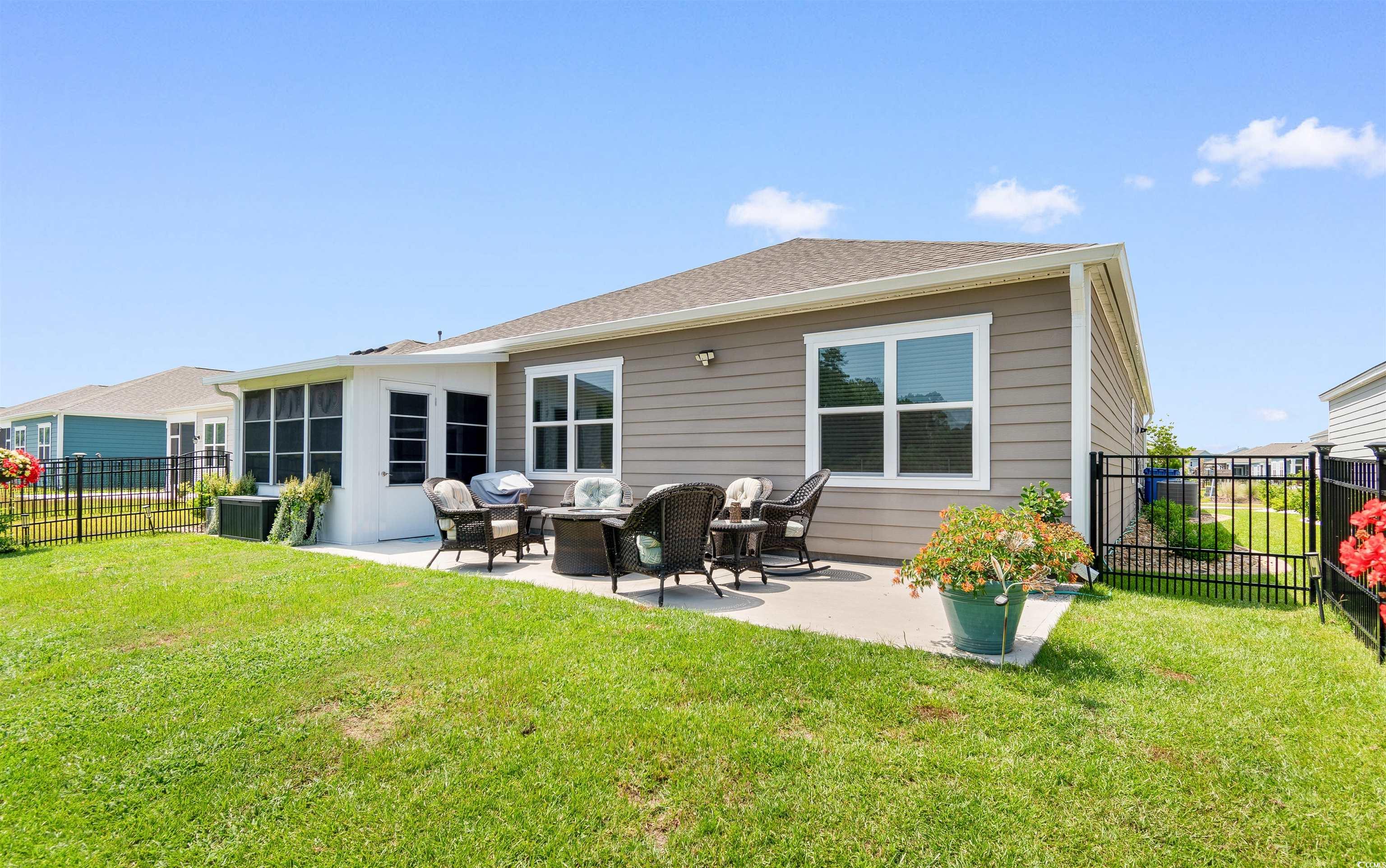 2438 Polaris Path Myrtle Beach, SC 29577 - Photo 31 of 40 Back of property with a patio area and a fenced backyard