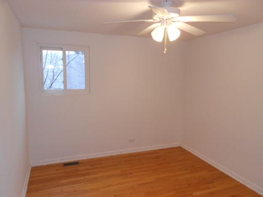 14 Highview Avenue Addison, IL 60101 - Photo 11 of 13 wooden floor in an empty room with a window
