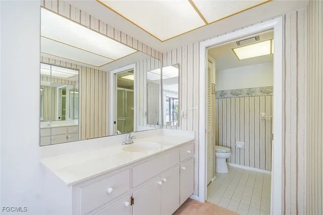 a bathroom with a sink a mirror and a shower